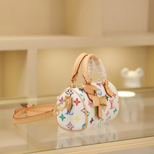Alternative view of 🔥M13391 White Color This Nano Speedy handbag features a compact silhouette crafted from Monogram coated canvas with calf leather trim, showcasing the vibrant spirit of the Louis Vuitton x Takashi Murakami reissue collection through its bright hues.Toron handles and a dazzling padlock pay homage to the House's travel heritage, while a removable and adjustable shoulder strap and a distinctive LV x TM key case complete the ensemble.10 x 7.5 x 16 cm (H x W x L) Monogram coated canvas Cowhide leather trim Fabric lining Metal hardware Zipper closure Removable key case Shoulder strap: Removable, adjustable Strap half-length: 45.5 cm Strap half-length adjustable to: 54.0 cm Handles: Double handles